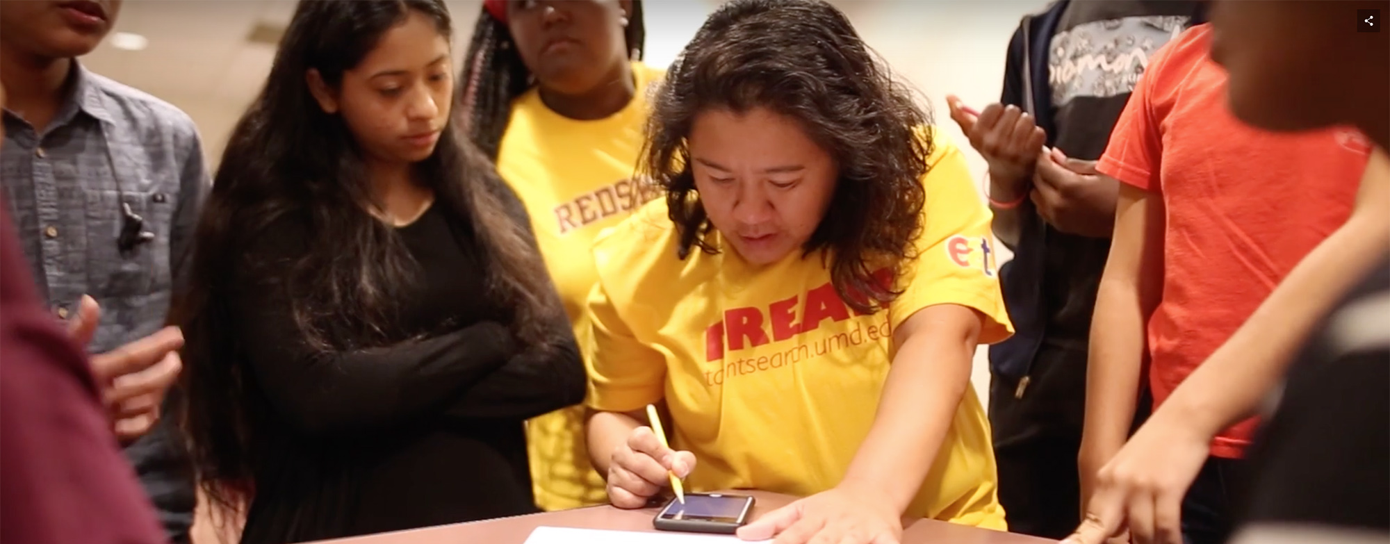 UMD student sitting on step reading